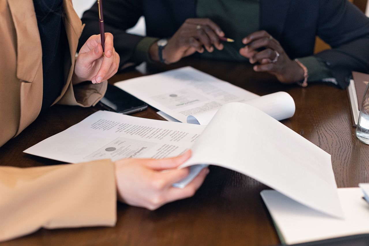 Professionals coordinating payroll, benefits, and workplace services